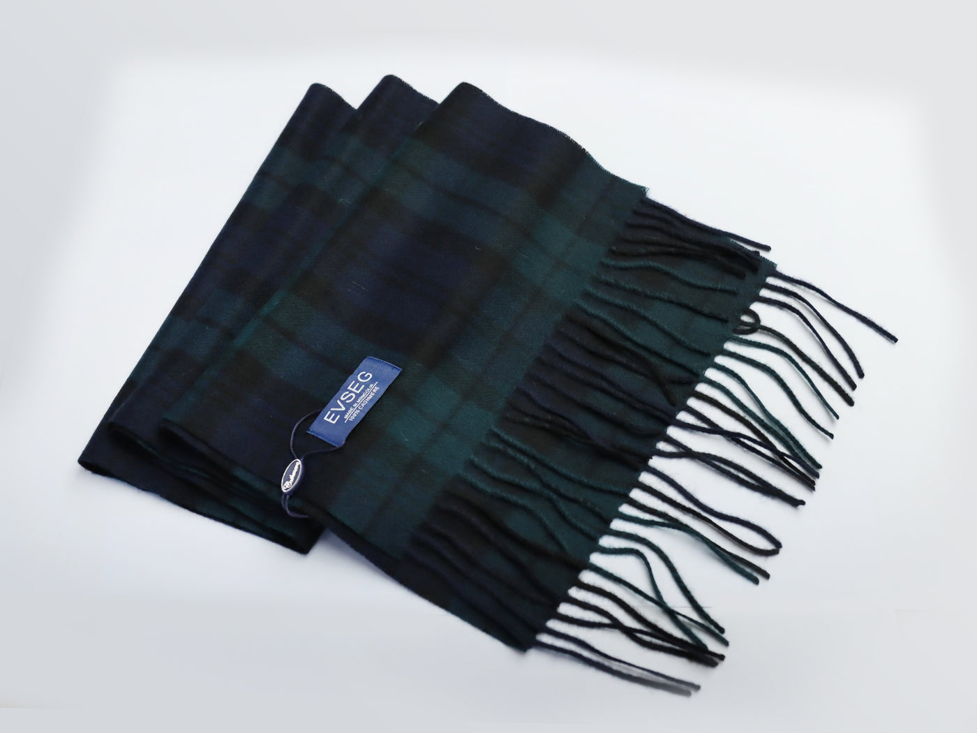 Premium Mongolian cashmere scarf in green and black plaid pattern with fringed edges and EVSEG label.