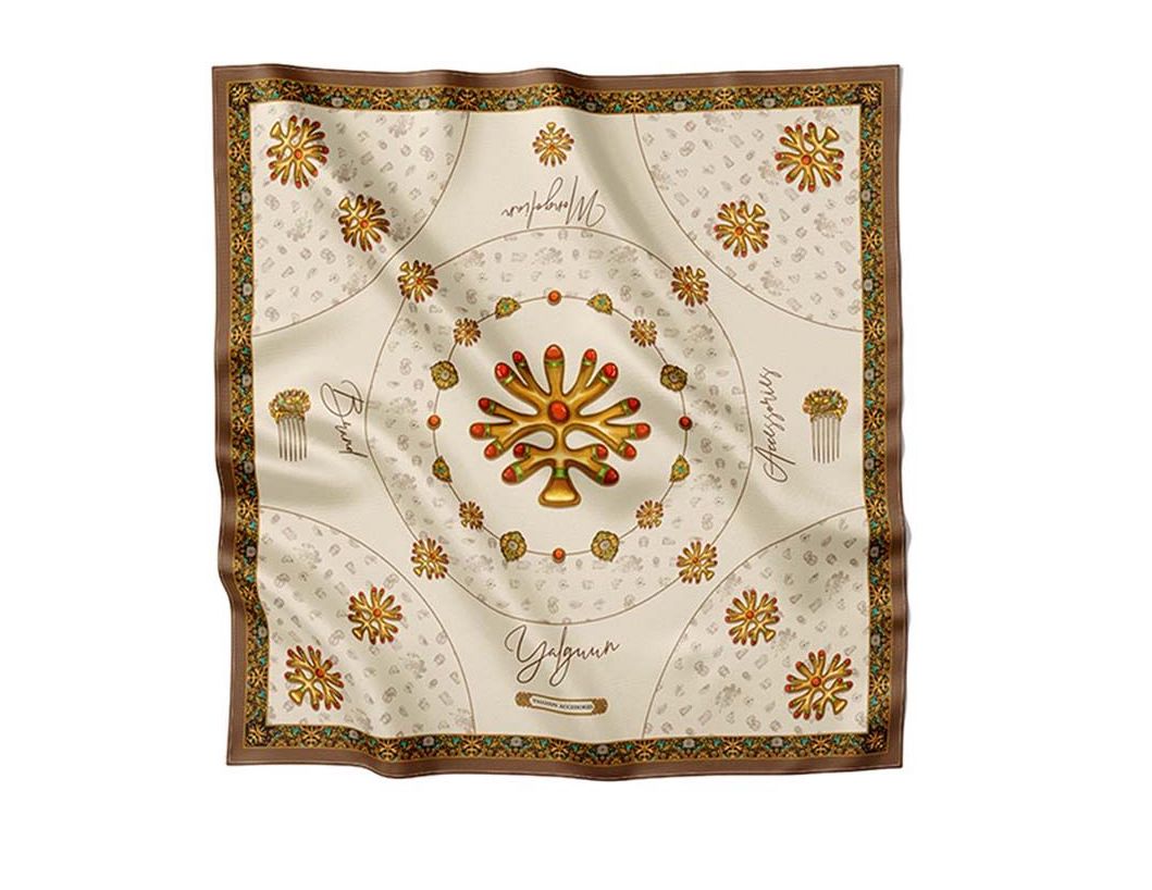 Luxurious beige silk scarf adorned with golden traditional motifs, intricate ornaments, and decorative patterns, exuding elegance and sophistication.