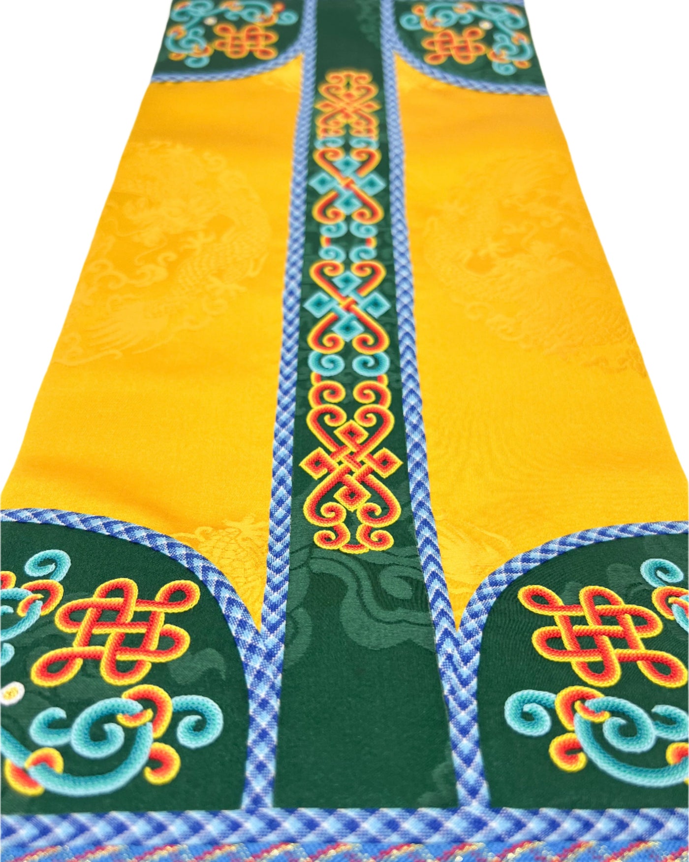 The Eternal Knot, the King's Bracelet, the Queen's Chariot, the Khadag (ceremonial scarf), and the Spiral Pattern are intricately embroidered. The design is finished with fishbone stitching and decorated with a coin braid stitch on yellow and blue dual tone silk. 