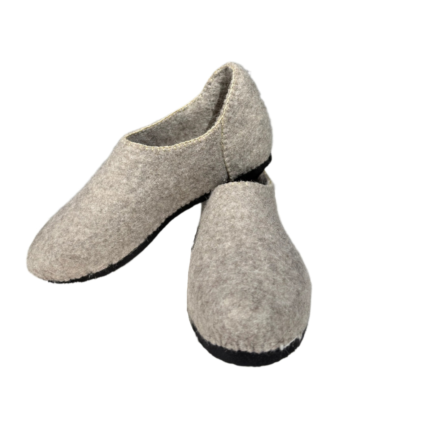 Handmade sustainable felt shoes made from natural wool with a cozy, minimalist design. Ideal for eco-conscious and winter wear.