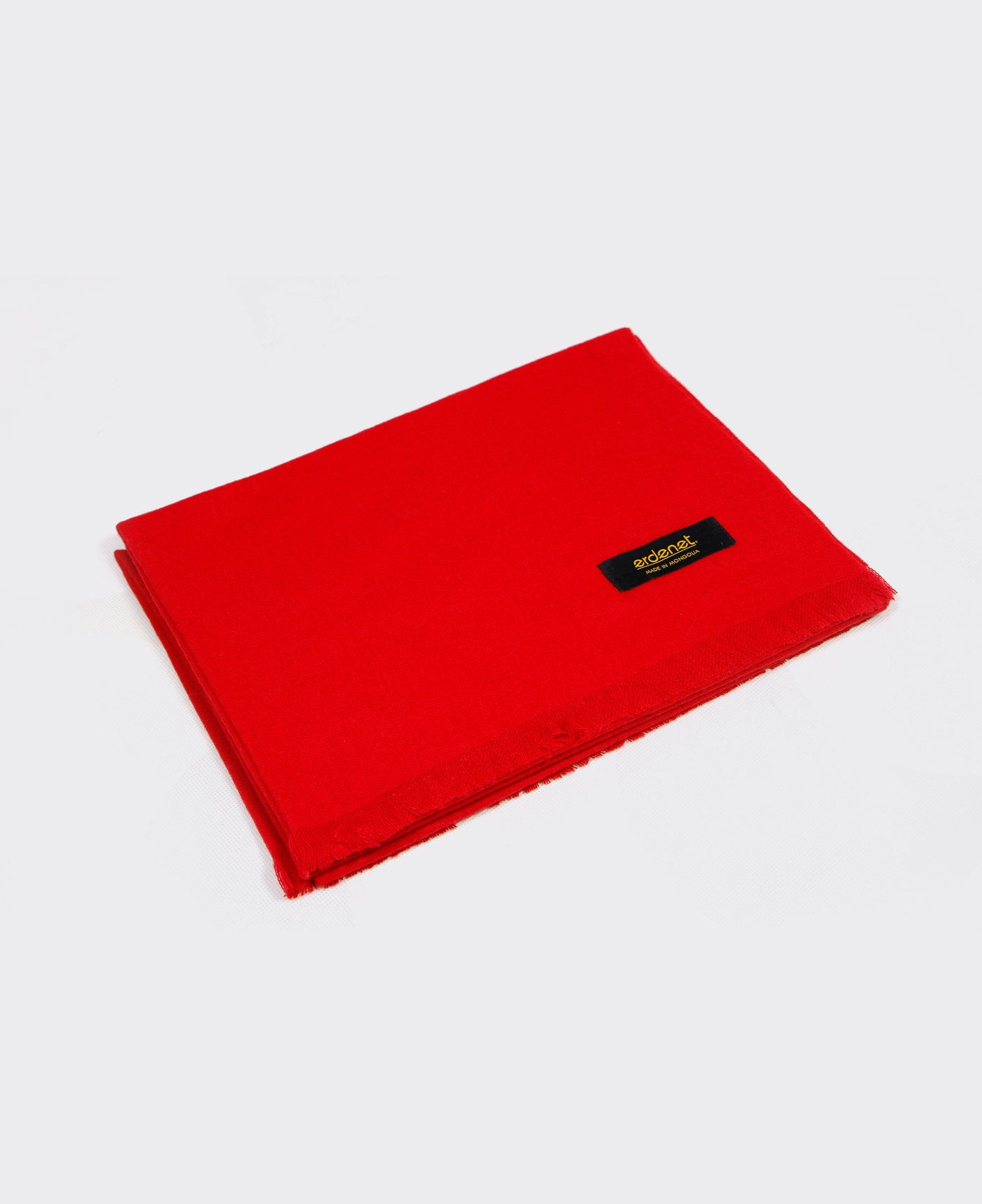 Bright red cashmere shawl with fringed edges, sustainably made in Mongolia, offering elegance, warmth, and softness