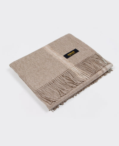 A natural beige Mongolian cashmere plaid with fringe detailing, made from 100% sustainable and soft cashmere.