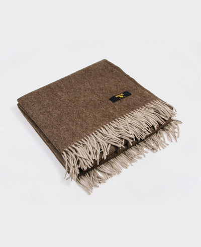 Brown yak wool plaid with fringed edges, sustainably sourced from Mongolia, offering warmth and comfort