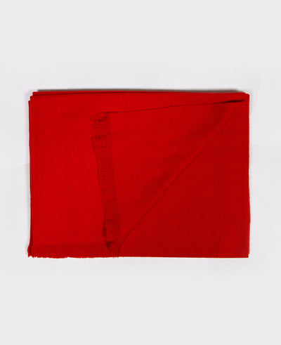 Bright red cashmere shawl with fringed edges, sustainably made in Mongolia, offering elegance, warmth, and softness