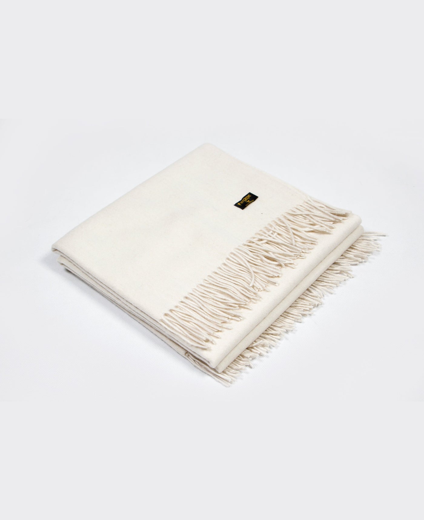 White cashmere  plaid with a red line and fringed edges, sustainably sourced from Mongolia, offering warmth and comfort