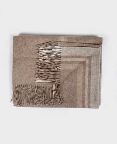 A natural beige Mongolian cashmere plaid with fringe detailing, made from 100% sustainable and soft cashmere.