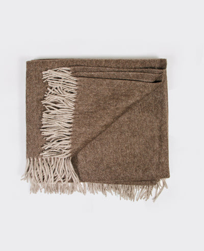 Brown yak wool plaid with fringed edges, sustainably sourced from Mongolia, offering warmth and comfort