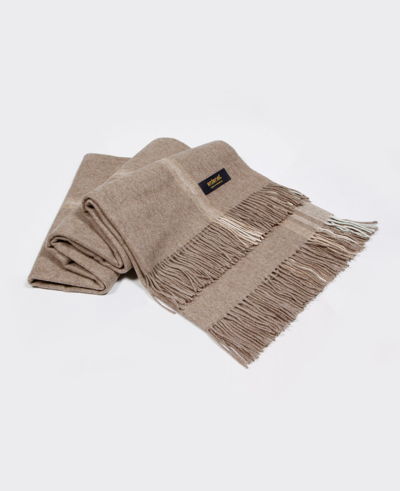 A natural beige Mongolian cashmere plaid with fringe detailing, made from 100% sustainable and soft cashmere.