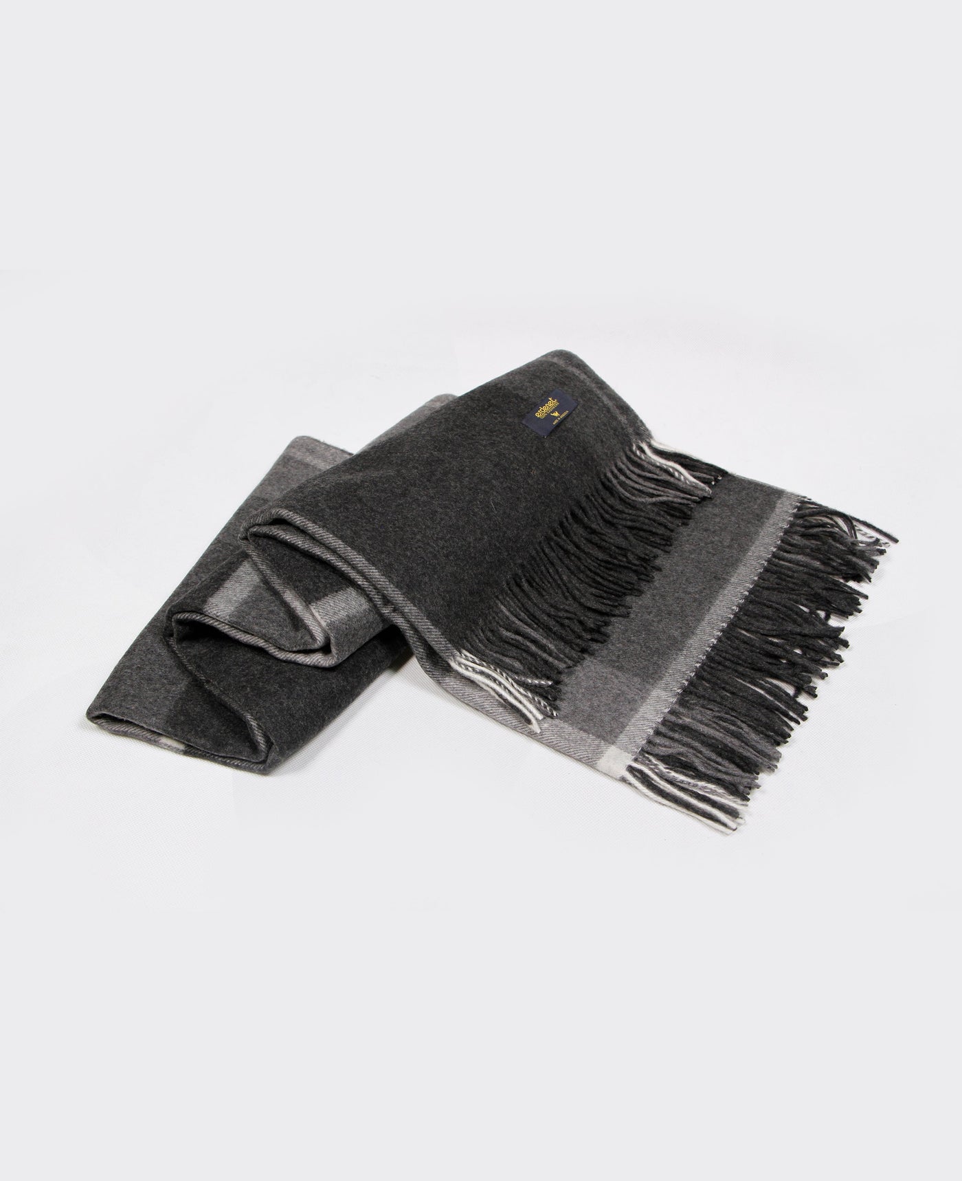 A luxurious dark gray Mongolian cashmere plaid with elegant fringe details, made from 100% sustainable cashmere.