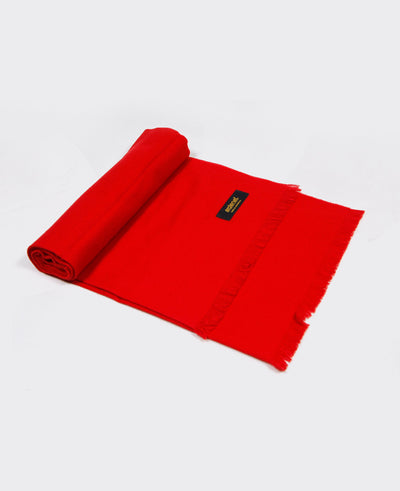 Bright red cashmere shawl with fringed edges, sustainably made in Mongolia, offering elegance, warmth, and softness