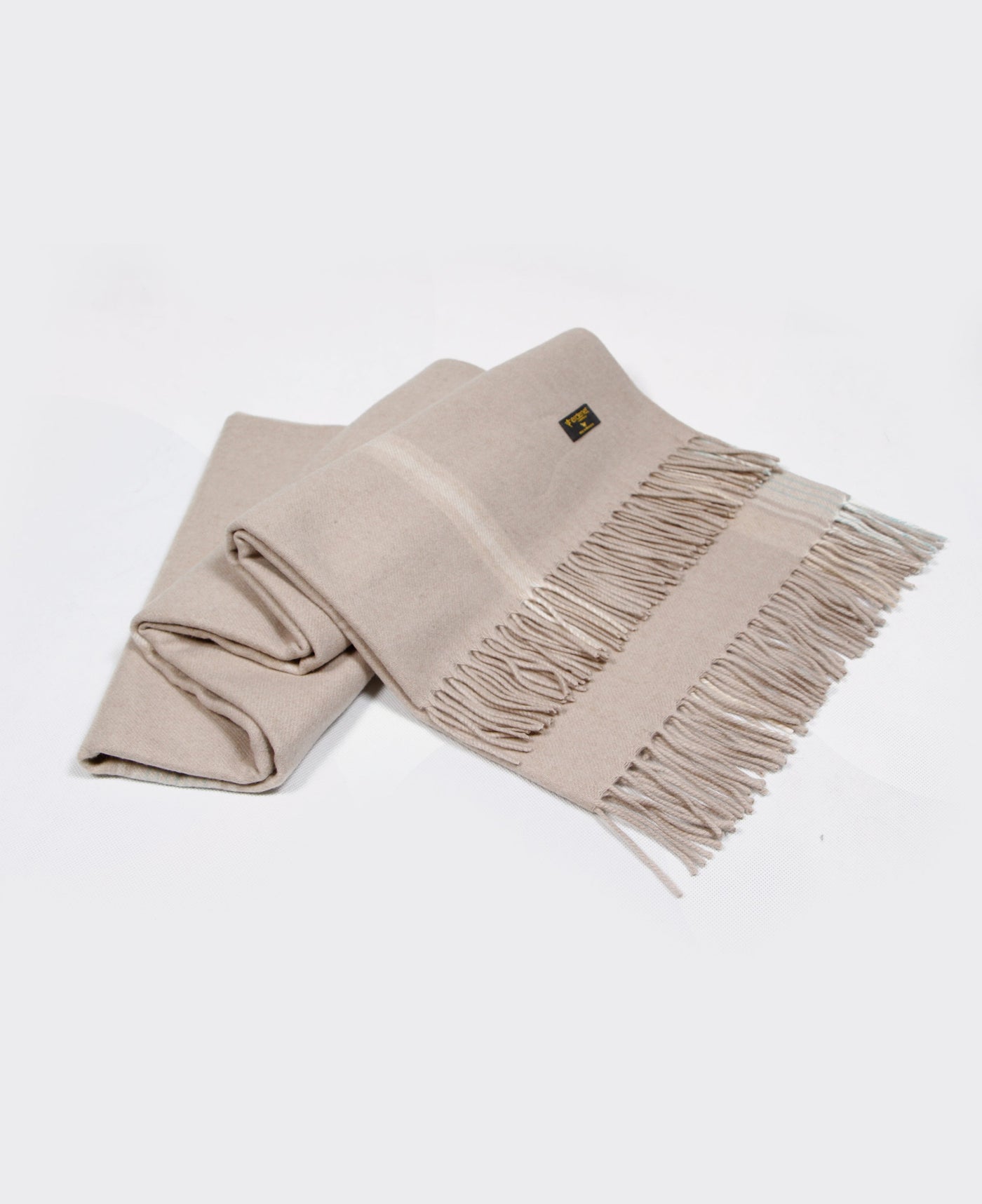 A light beige Mongolian cashmere plaid with fringe detailing, made from 100% sustainable and soft cashmere.