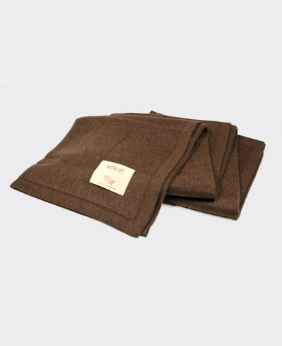 Brown yak wool blanket with stitched edging, made in Mongolia, offering warmth, softness, and sustainability.